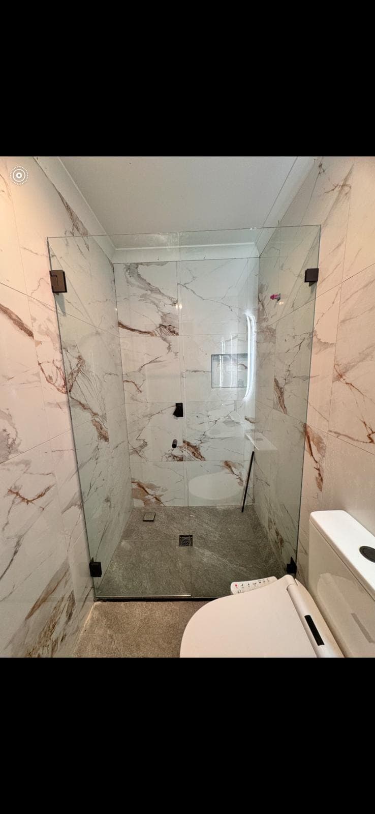 Renovation photo: marble look tiled shower