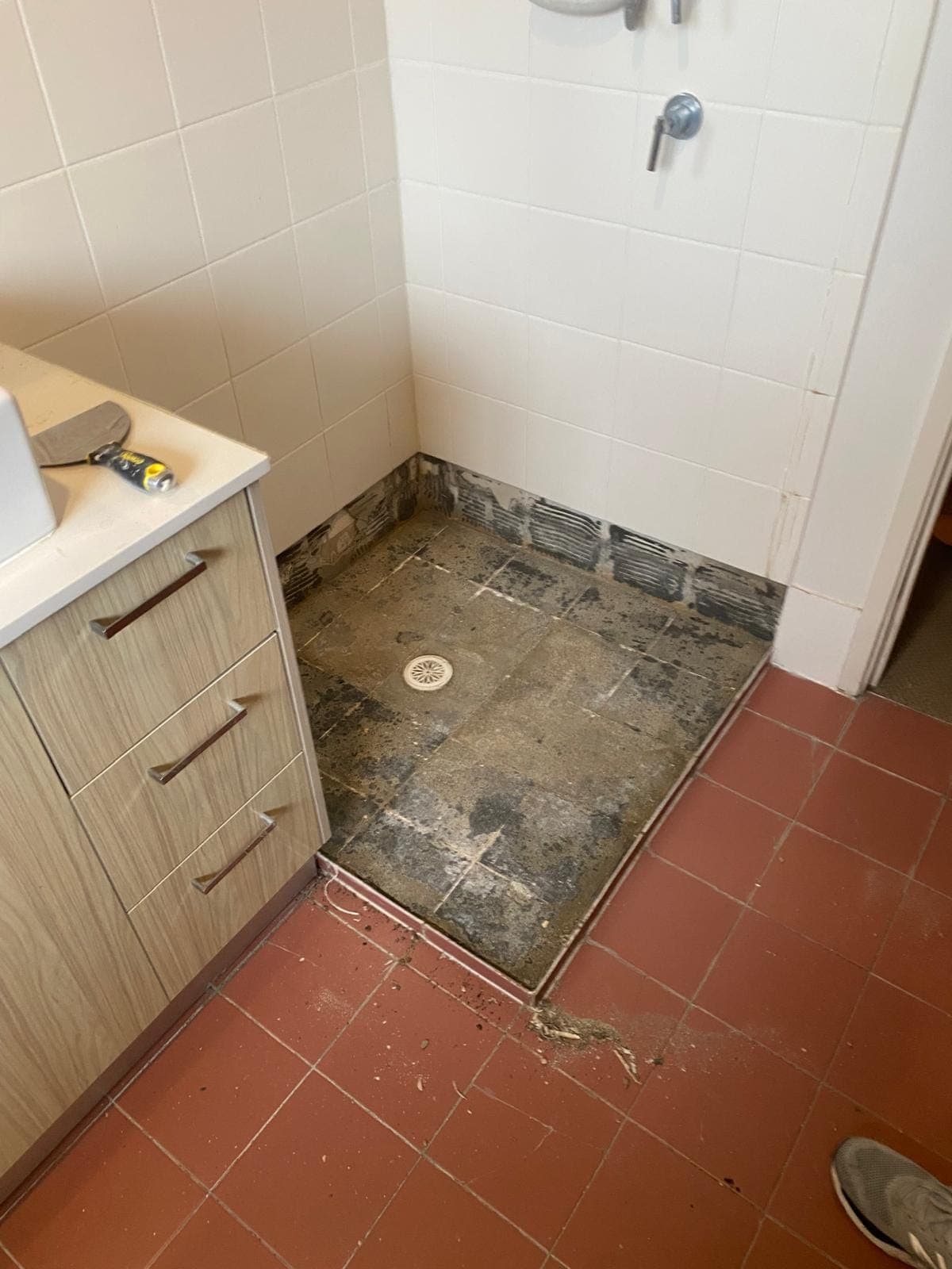 Renovation photo: bathroom floor prep with vanity installed